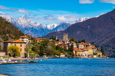 The village of santa maria rezzonico, on lake como, on a spring day, with its tower and the alps.