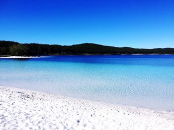 Scenic view of sea against clear blue sky