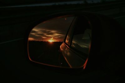 Reflection of sky in side-view mirror