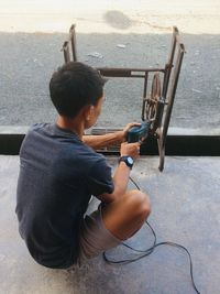 Rear view of boy sitting on chair
