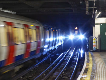 Train at railroad station at night