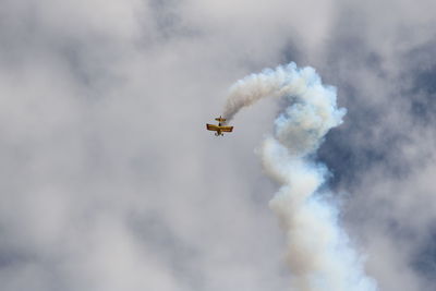 Low angle view of airplane flying in sky