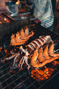 High angle view of meat on barbecue grill