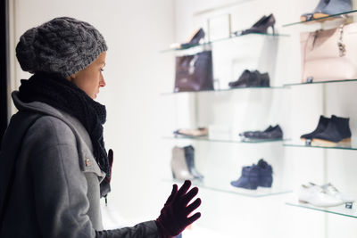 Mid adult woman standing in retail store