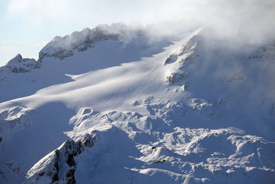 Aerial view of snowcapped mountains against sky