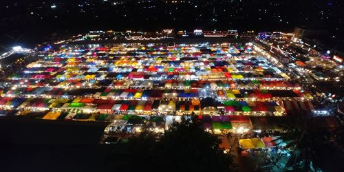 Illuminated city against sky at night