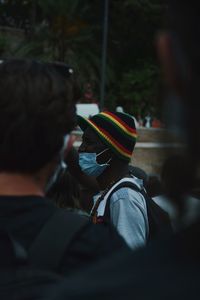 View of man wearing flu mask standing outdoors