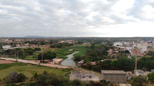 High angle view of houses in town against sky