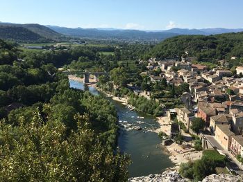 High angle view of river by houses against sky