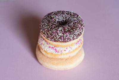 Close-up of multi colored candies against pink background