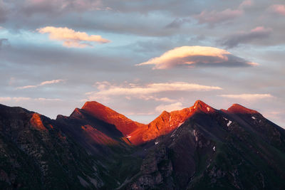 Scenic view of snowcapped mountains against sky during sunset