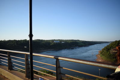Scenic view of river against clear blue sky
