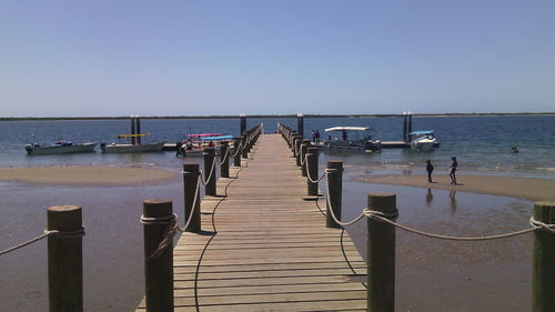 Empty jetty leading to calm sea