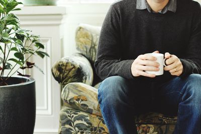 Close-up of man holding mug