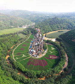 High angle view of agricultural field against sky in city