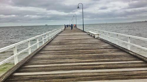 Pier over sea against sky