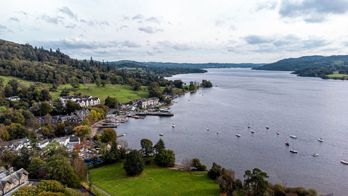 High angle view of river amidst mountains against sky