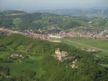 High angle view of green landscape against sky