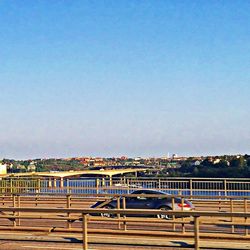 View of bridge in city against clear sky