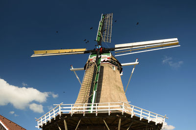 Low angle view of traditional windmill against sky