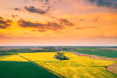 Scenic view of field against sky during sunset