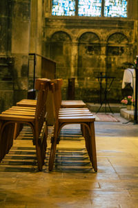 Empty chairs and table in building