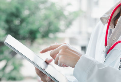 Midsection of person holding mobile phone