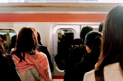 Rear view of people at train