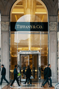 People walking in front of building