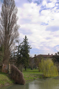 Scenic view of field against cloudy sky
