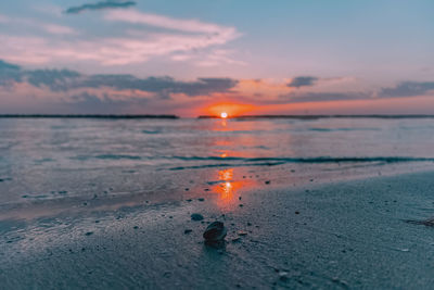 View of a beach with a sunrise in the background