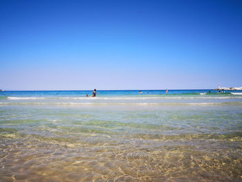 Scenic view of sea against clear blue sky