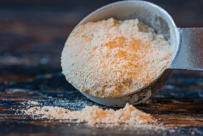 Close-up of maca powder in spoon on table