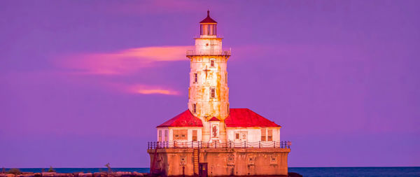 Lighthouse by sea against sky during sunset ,chicago city,usa