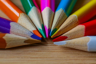 Close-up of multi colored pencils on table