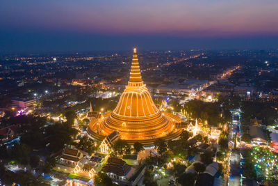 Aerial view of illuminated buildings in city at night