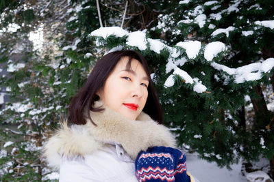 Portrait of a smiling young woman in snow