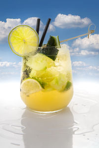 Close-up of drink on glass against sky