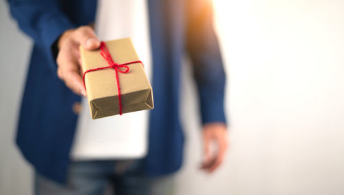 Close-up of human hand holding box