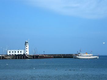 Tranquil seascape with lighthouse and cruise ship