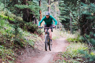 Man riding bicycle in forest