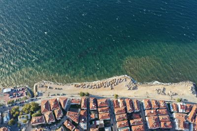 High angle view of buildings by sea