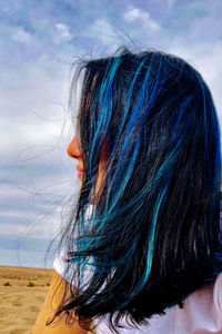 Rear view of woman with hair against sky