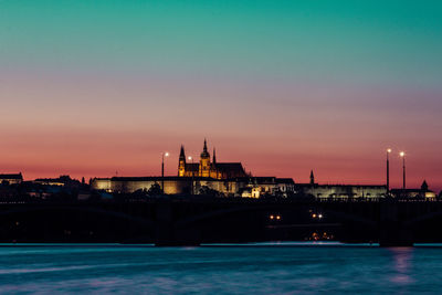 View of bridge over river at sunset