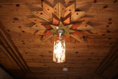 Low angle view of illuminated pendant lights hanging from ceiling