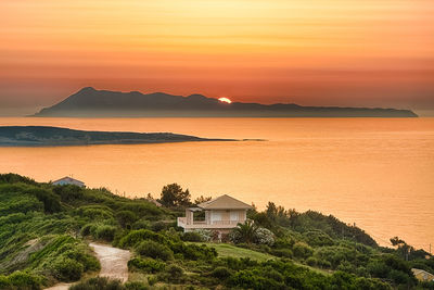 Scenic view of sea against orange sky