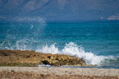 Scenic view of sea waves splashing on rocks