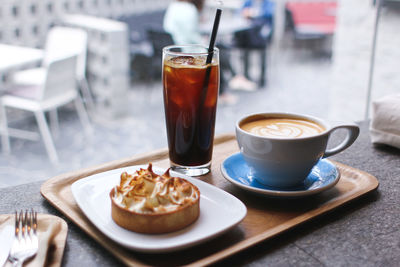 Close-up of coffee and breakfast served on table in restaurant