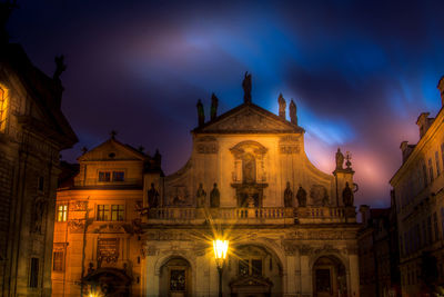 Low angle view of illuminated building against sky at night