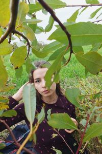 Portrait of a young woman with leaves